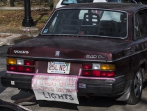 Sign on car bumper: Human Rights not Holiday Lights