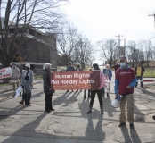 Protestors at Fernald - banner: "Human Rights not Holiday Lights"