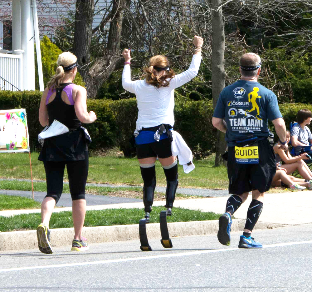 Young woman with two blade legs in 2016 boston marathon cheering