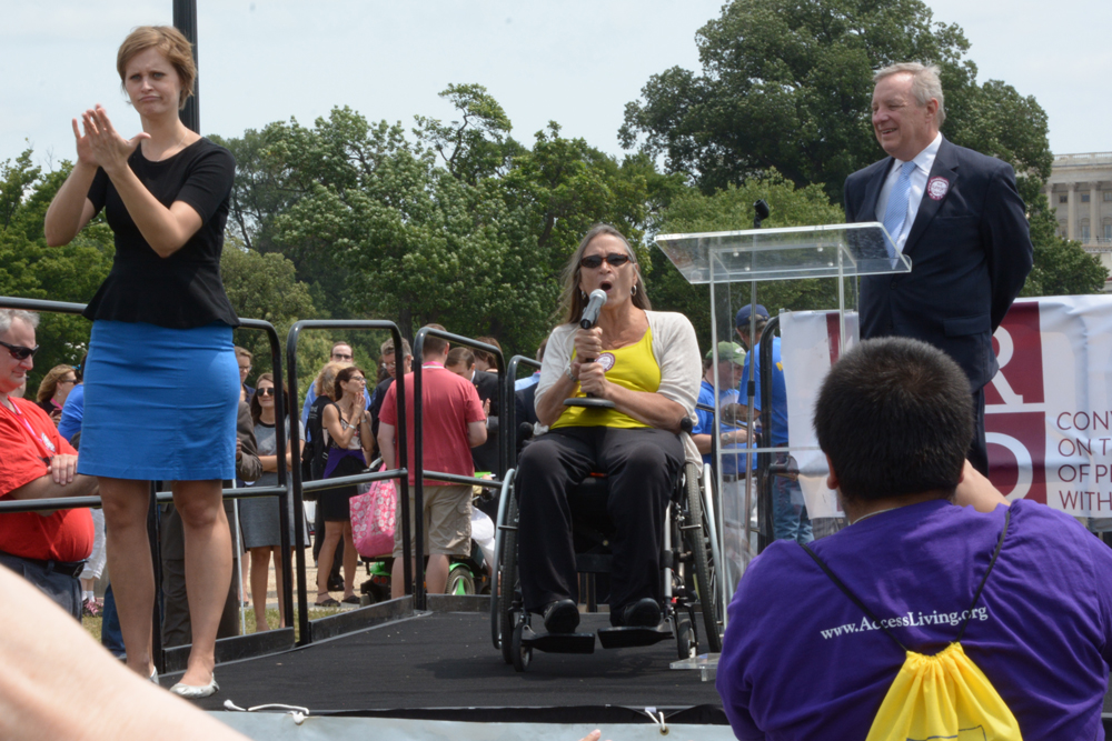 Marca speaking at NCIL Rally 2014, next to Senator Harkin