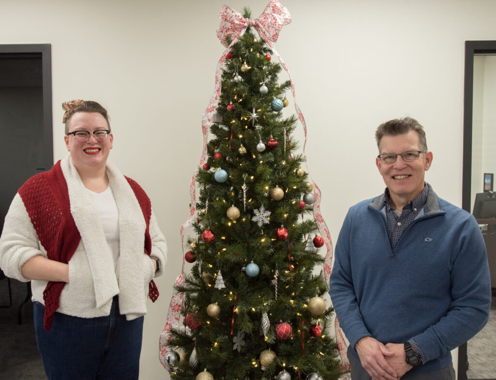 Erin and Lou beside a Christmas Tree