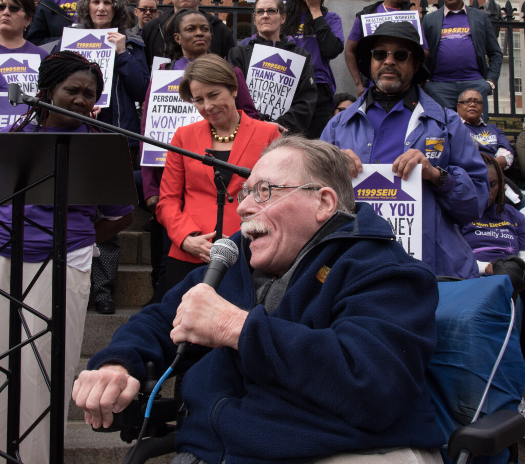 Paul at 2019 PCA Rally with now-governor Maura Healey in background