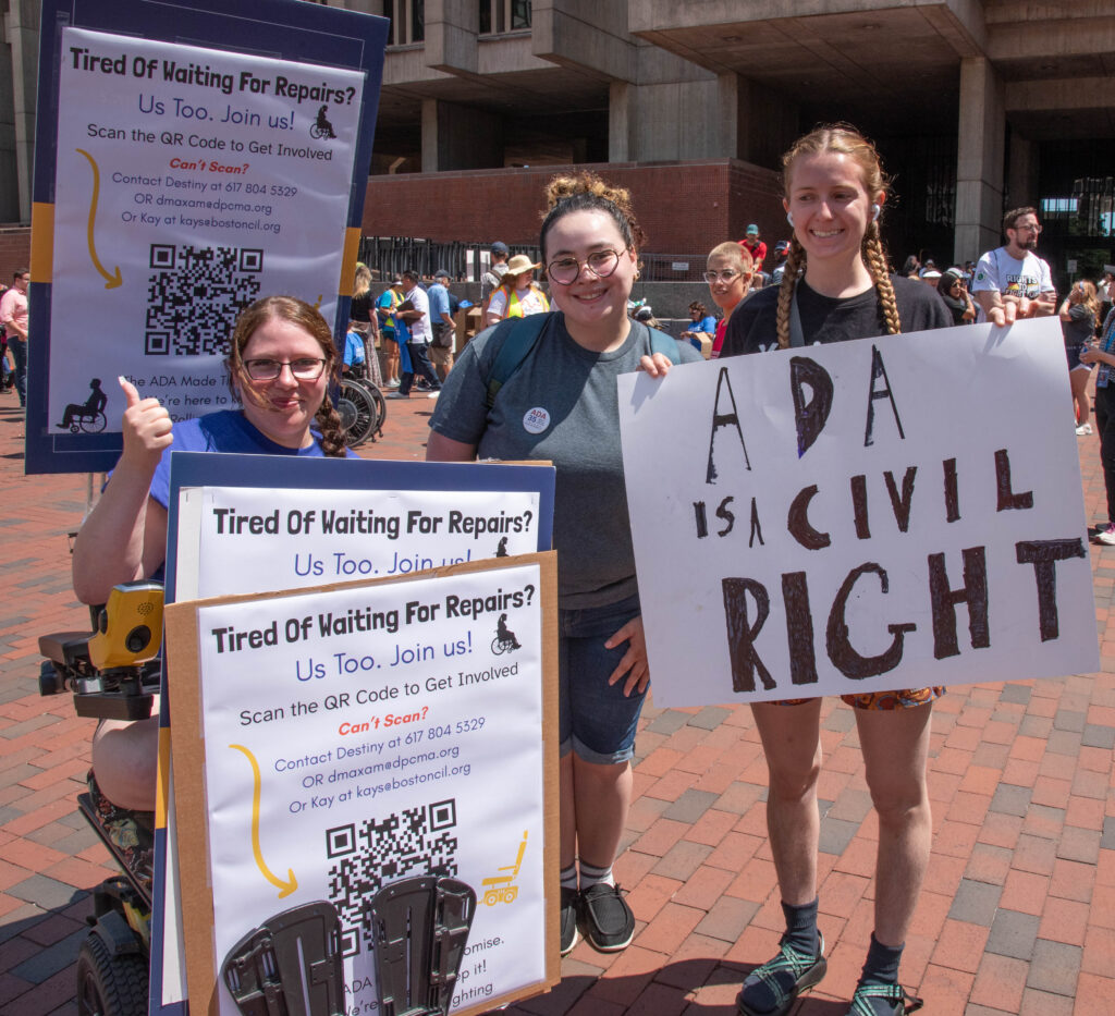 women with wheelchair repair sign and ada is a civil right sign