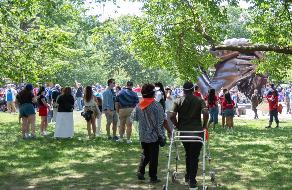 at the Embrace - trees, grass and marchers