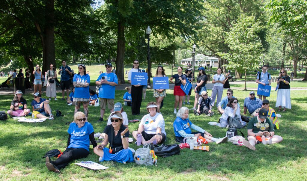 attendees sitting in the shade