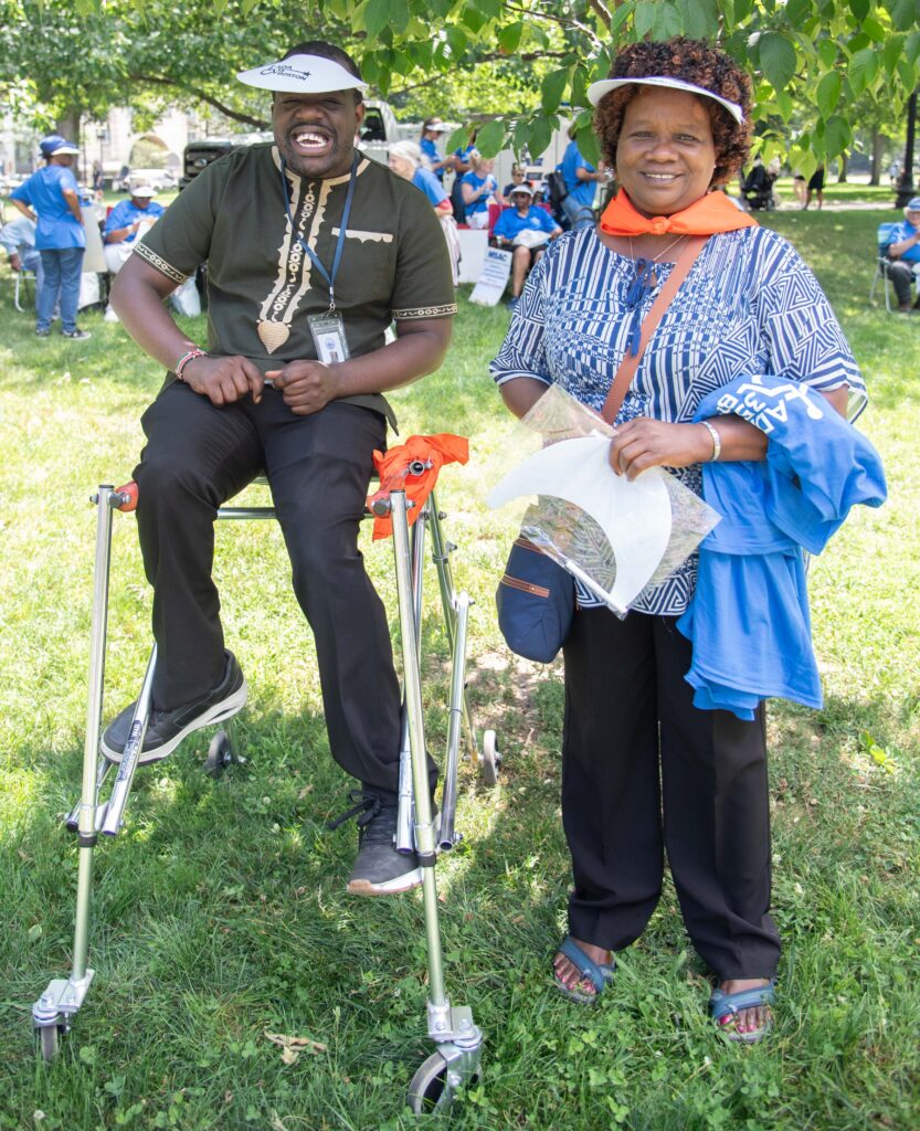 Man sitting on walker with woman