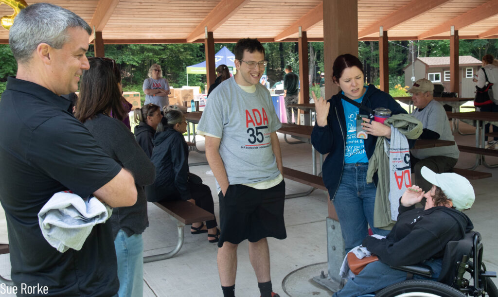 Paul and Desi (EasterSeals MA) and others talking