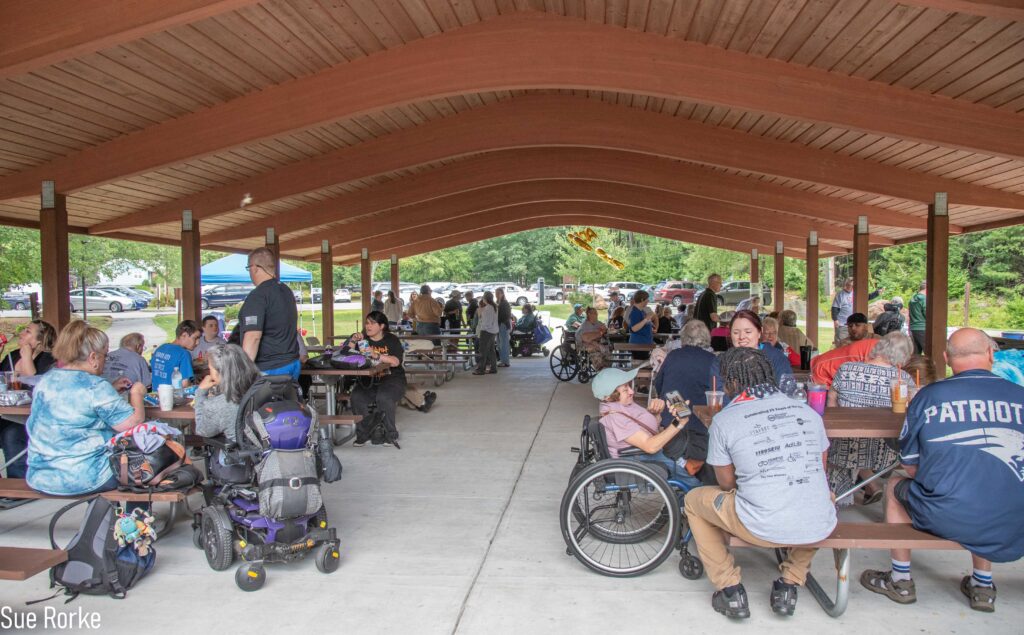 View of pavilion with many people eating lunch