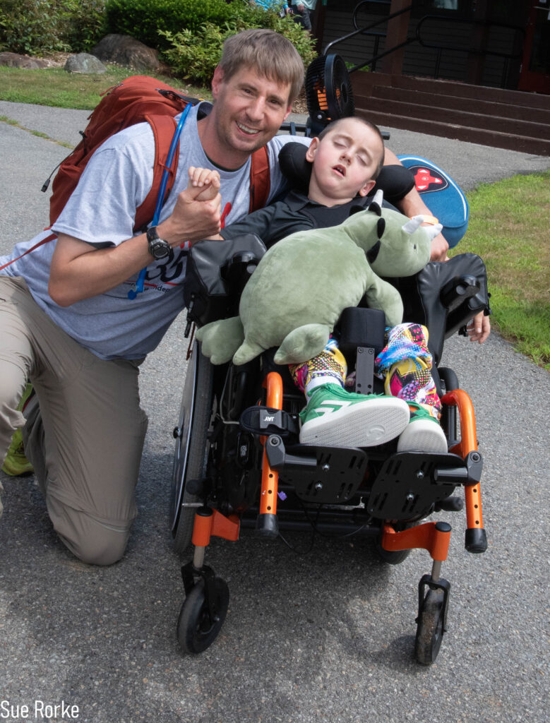 man and son, son is in wheelchair with a tricerotops