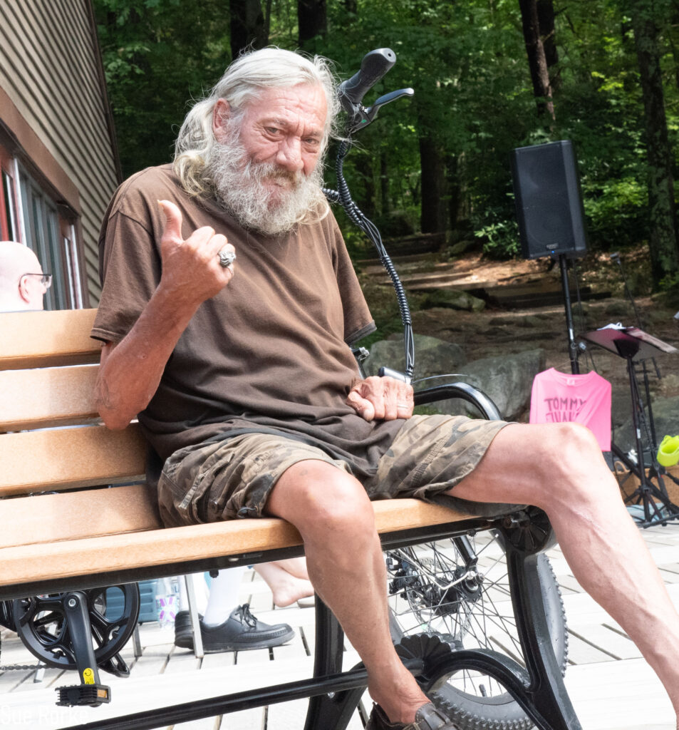 Man on bench giving thumbs up