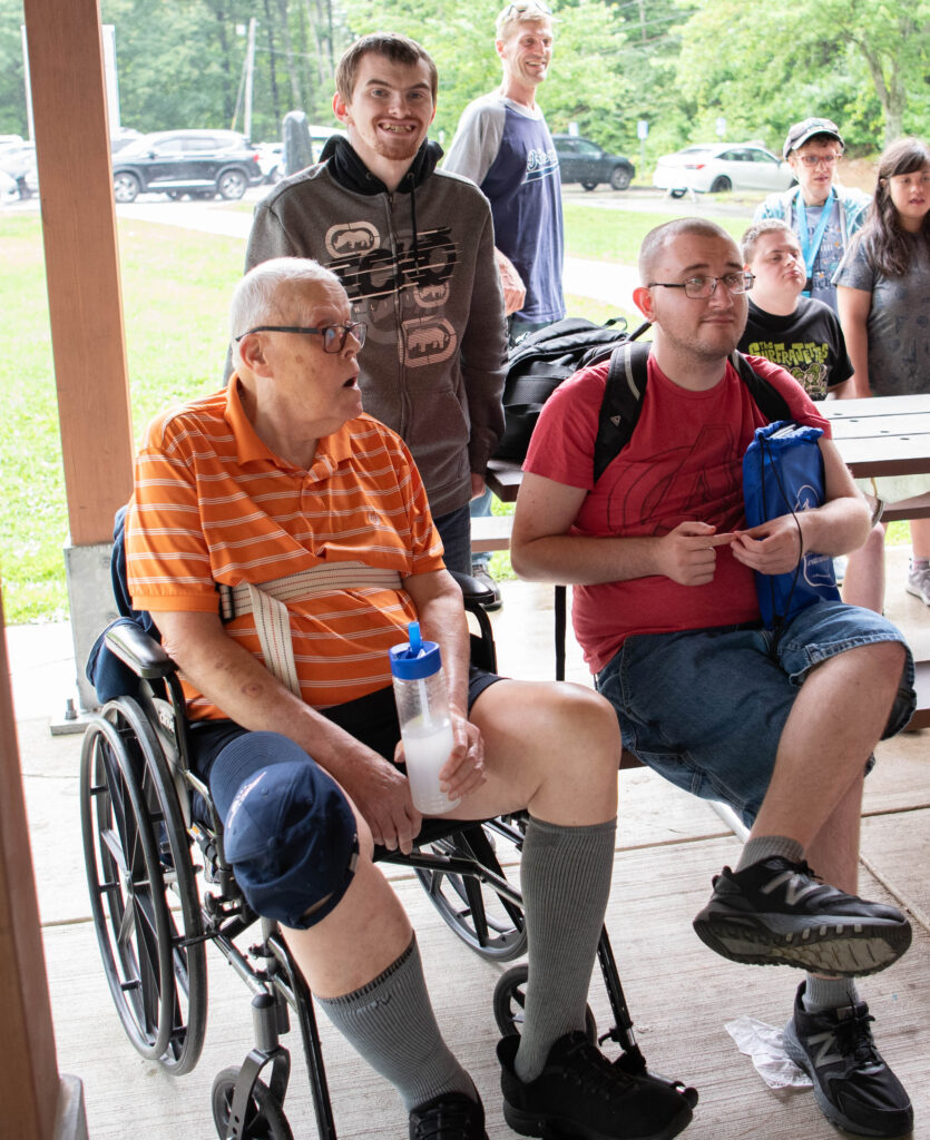 3 men at picnic tables